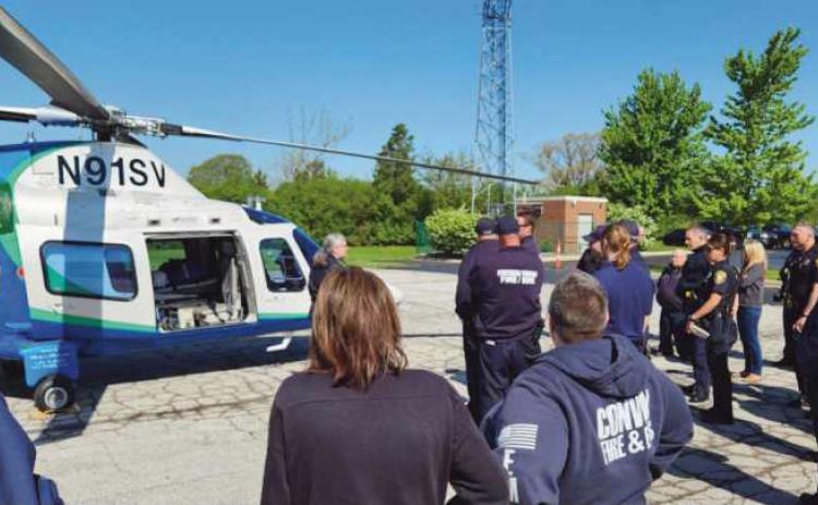 By Walter Celley Pilot Meghan Newyear instructs first responders on helicopter landing zone safety.