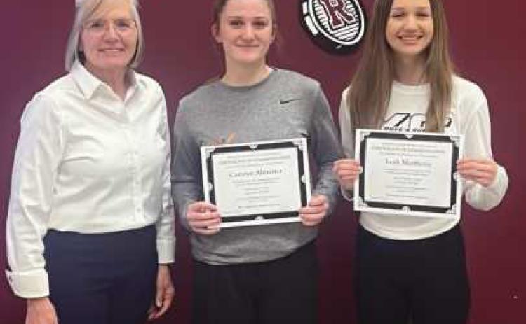 Left to right: Board President Jackie Huffman with Camryn Almester and Leah Matthews.