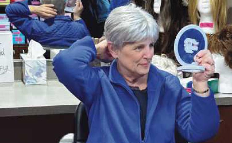 Peggy Keyes tries on her new wig.