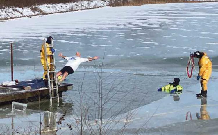 Bulldog Foundation vice president Doug Miller falls back-first into the frigid waters.