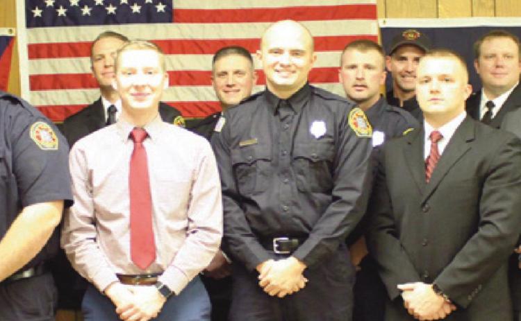 On December 15, five personnel were sworn in to serve the Perrysburg Township Fire Department. They are front row from left, Brian Perkins, Jacob Rands, Joe Gernheuser, Jaren Wickham and Levi Kuebler. Behind them are members of the department and they are flanked by Deputy Chief Jim Rodriguez, back row left and Chief Tom Brice, right.