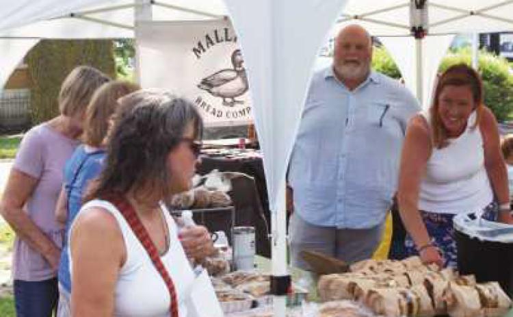 Stroll the Street attendees peruse bread and baked goods.