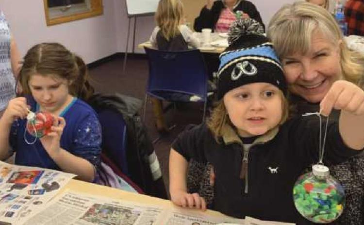Young artists create holiday ornaments at library program