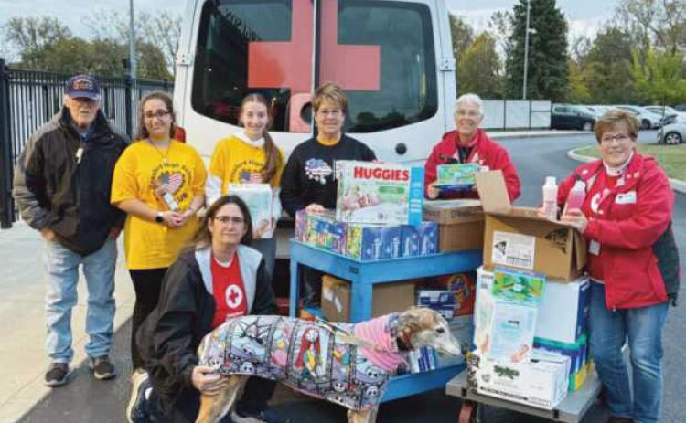 From left: James McVicker, Ella Cole, Kim Ferguson and Bubbles, Leah Gladieux, Martha Fellman, Gloria Liedigk and Kathy McVicker with donations for the 180th.