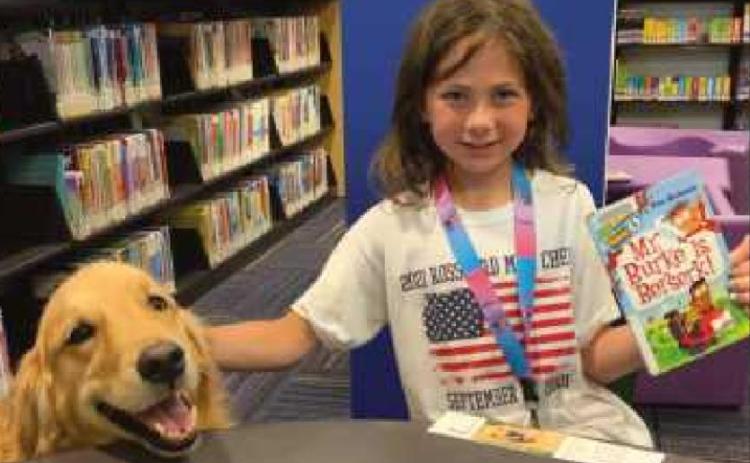 Area children read with the dogs at library