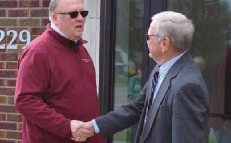 Above, Mayor Neil MacKinnon III congratulates former mayor Mark Zuchowski after the ribbon-cutting at the building at 229 Eagle Point Road.