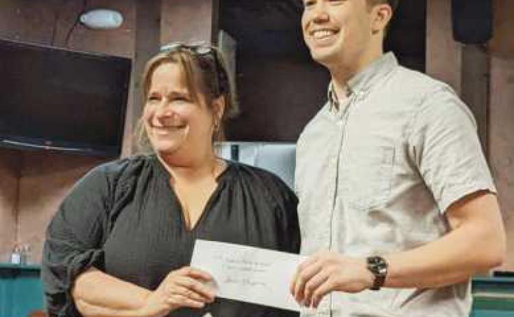 Above, Waterville Chamber Director Jackie Lehman, left, presents a check to Jason Chappuies, winner of the T-shirt design contest for the 50th annual Roche de Boeuf festival. The T-shirts will be for sale at the festival.