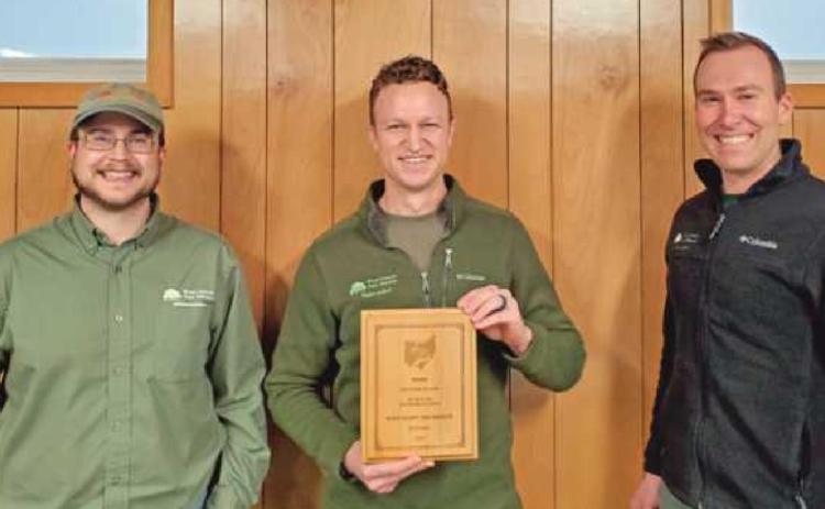 Craig Spicer, center, program naturalist, displays the award the park district received for its geochase program. Flanking him are left, Rob Brian, operations manager, and Jim Witter, program coordinator.