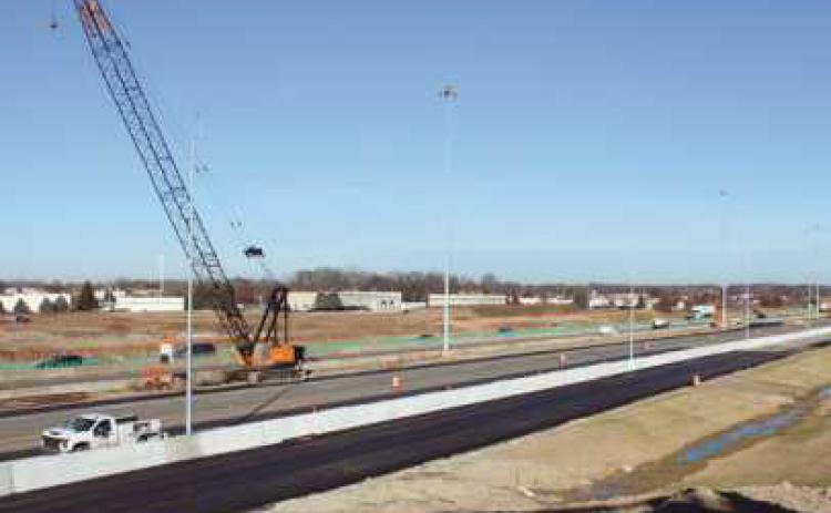 Road crews put the finishing touches on I-475 northbound lanes in preparation for the new traffic pattern.