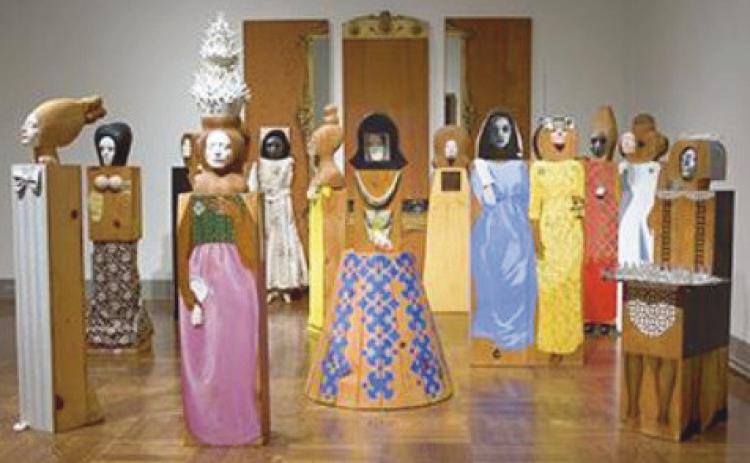 The exhibit includes “The Party,” an assemblage of 15 freestanding, life-size figures and three wall panels, with painted wood and carved wood, mirrors, plastic, television set, clothes, shoes, glasses and other accessories.