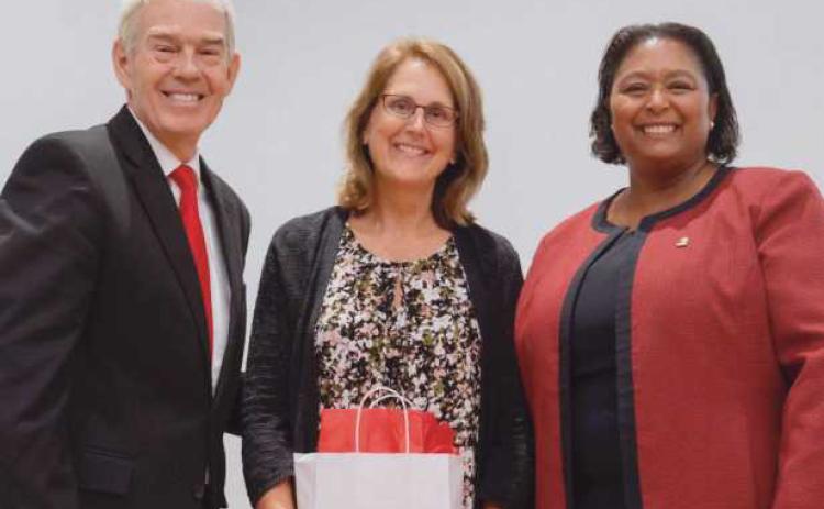 Ohio Department of Higher Education Chancellor Randy Gardner, left, and Owens President Dione Somerville, right, present the Presidential Teaching Award to Owens nursing professor Julie Lohse, center.