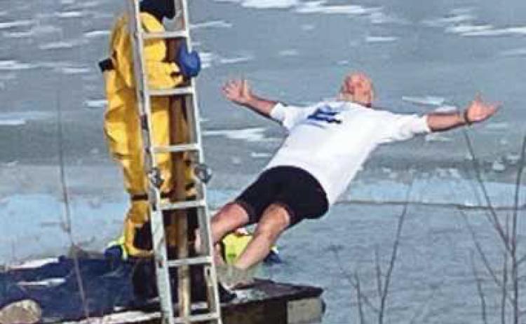 Bulldog Foundation Vice President Doug Miller falls backfirst into the frigid waters.