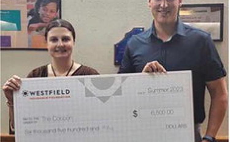 Kathy Mull, left, executive director of the Cocoon, with First Insurance Group agent, Matt Karaffa, right.