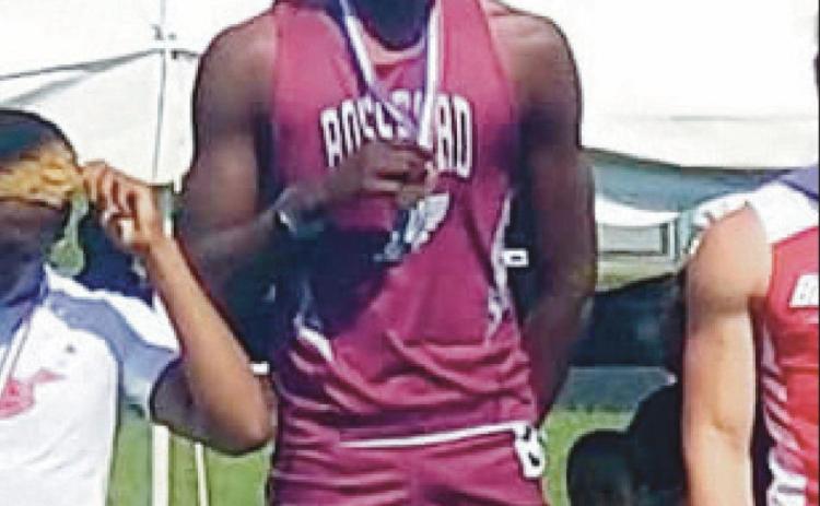 Above, RHS senior Jamari Croom stands atop the podium at the state track championship. Minutes later, he was congratulated, below, by another RHS state champ Ron Weber. Mr. Weber was at the meet cheering Jamari on exactly 50 years after earning his own state titles in the 120 yard high hurdles and the 180 yard low hurdles. “A class act all around, it was so cool to see one Rossford legend welcome another into legendary status,” said RHS head track coach Todd Eckel.