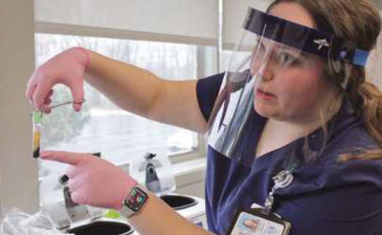 Hannah Guercio demonstrates how blood is separated in the centrifuge and the plasma extracted afterward. See drawing below.