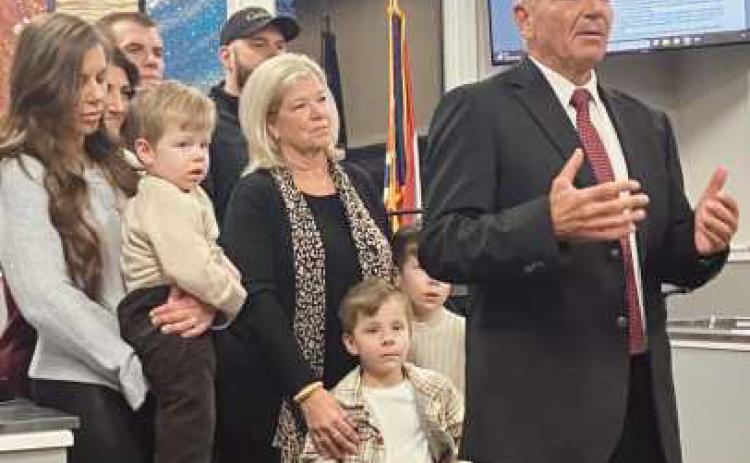 Fire Chief Syroka, right, speaks to the city council audience with his family beside him.