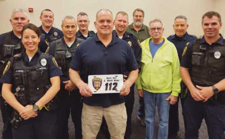 From left: Patrol Officer Chris Klewer, Patrol Officer Alicia Cryan, Patrol Officer Nick Owens, Sargeant Scott Mezinger, Lieutenant Dave Molter, retiring Deputy Chief Dave Nixon, Chief Matt Gazarek, Administrator Jon Eckel, Trustee Gary Britten, Lieutenant Jason Gladney and Patrol Officer Ryan Welch.