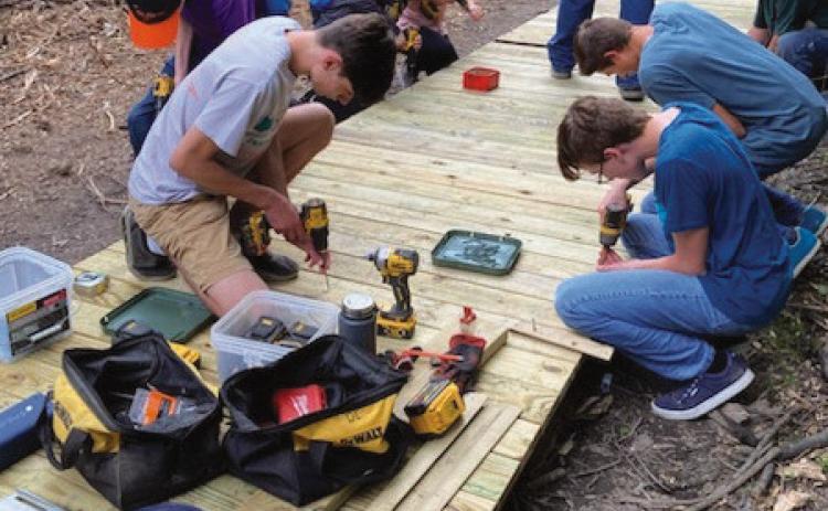 Area youth lay planks for W.W. Knight boardwalk