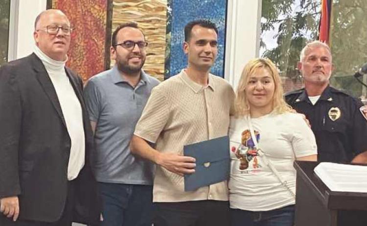 Mohammed Tahar (center) with Mayor MacKinnon (far left), Chief Kitzler (far right) and Tahar’s family.