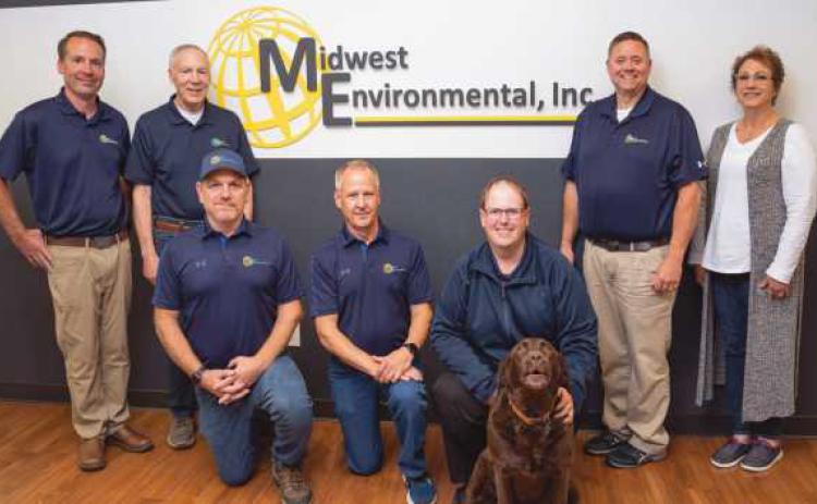 Above are, standing from left: David Bruhl, Dale Bruhl, Jr., Dan Wilburn, Lisa Sekela. Kneeling from left: Frank Montgomery, Scott Sellers, Justin Reitz and Darcy the company mascot.