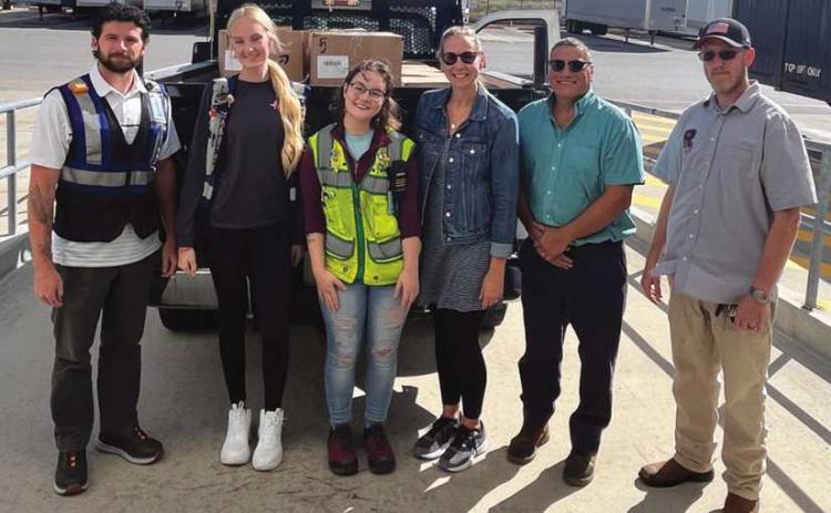 Amazon Rossford recently made a donation to Rossford Schools of hygiene and household items, school supplies and non-perishables—items that will directly support students and families in need. From left: Cody Igo (a Rossford graduate and member of the Bulldog Foundation), Brooke Moenter and Lexie Schraer, all from Amazon, and Regan Findling, Neal Applin and James Phillips of Rossford Schools.