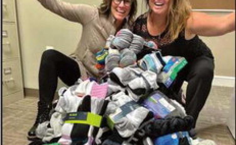 Sarah Bucher and Jordan Beach with some of the sock donations.