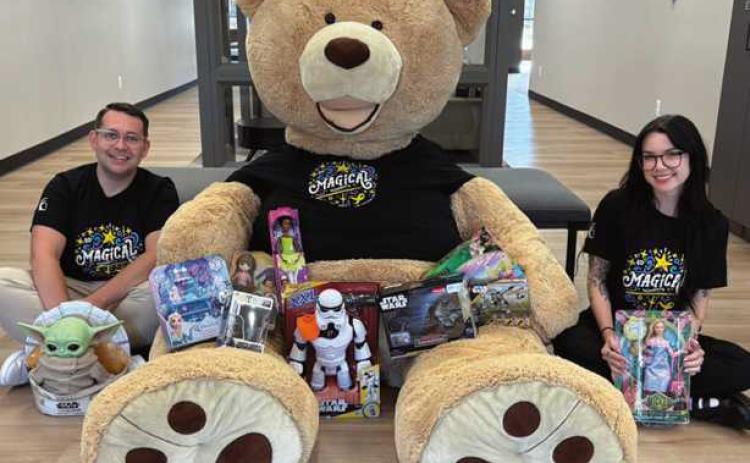 CCF employees Nick Parrino and Nicolette DeRespino pose with Freddy the Teddy and toy donations. Photo taken by Grace Alaska.