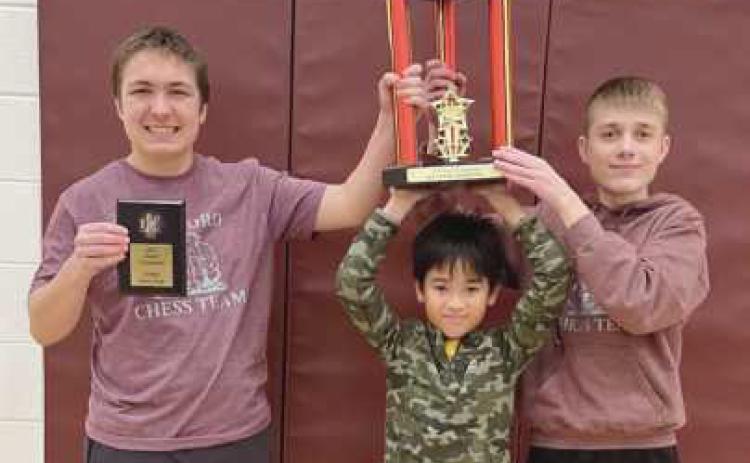 From left, Nathan Minor, Boa Nam Dang and Zeke Murtha with their first place K-8 section trophy.