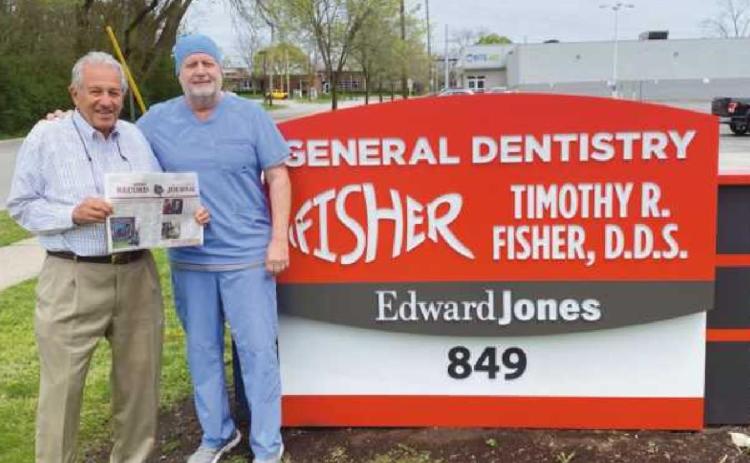 Dr. Zouhary stopped by his former dental office to visit with Dr. Tim Fisher and see the new sign. “Here’s a new take on the Rossford Record being read everywhere,” he added.