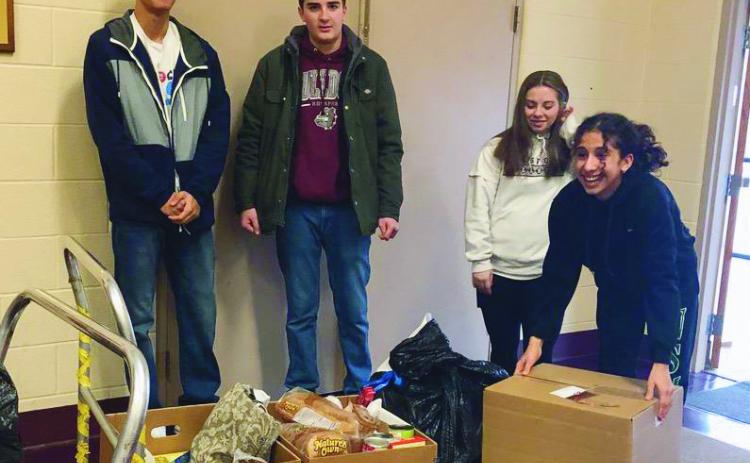 Student helpers, from left, Noah Paul, Mason Vascik, Natalie Weaks and Claire Drerup, helped load up items for families.