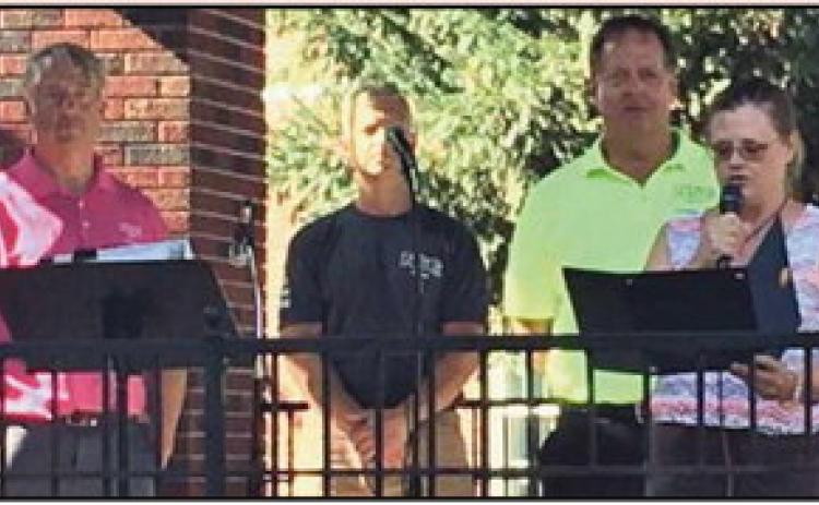 Joining Caroline Zuchowski Eckel, acting mayor, at Stroll the Street, are from left: Kyle Sword, NSG manager of business development; David Imbrogno, plant manager; and Steve Weidner, NSG Pilkington president and head of architectural glass North America.