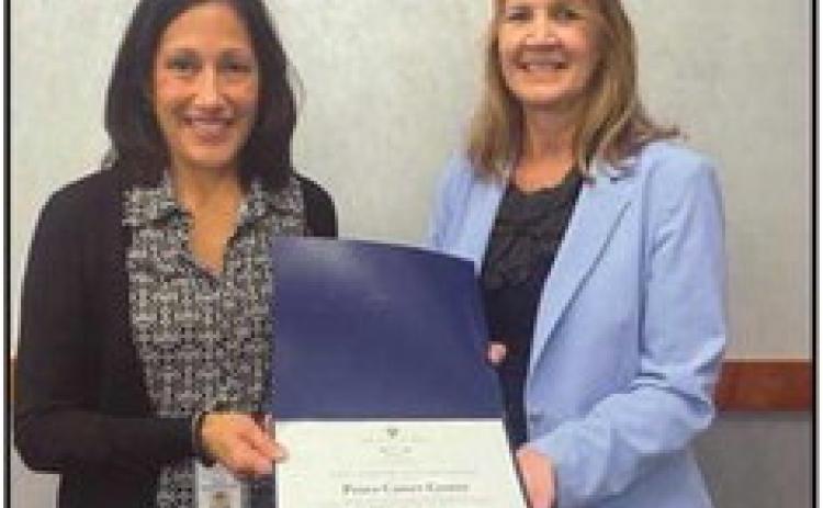 Penta Treasurer Carrie Herringshaw, left, accepts a perfect audit award from Lori Brodie of the auditor of state’s office.