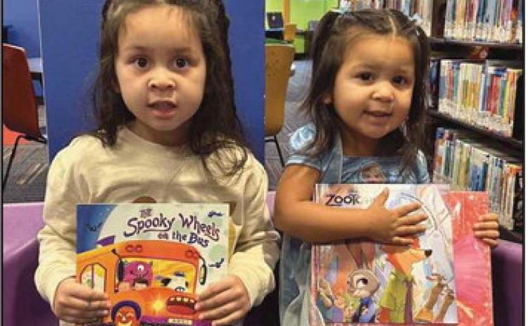 Left to right: Lavariah and Ameliah with their new books.