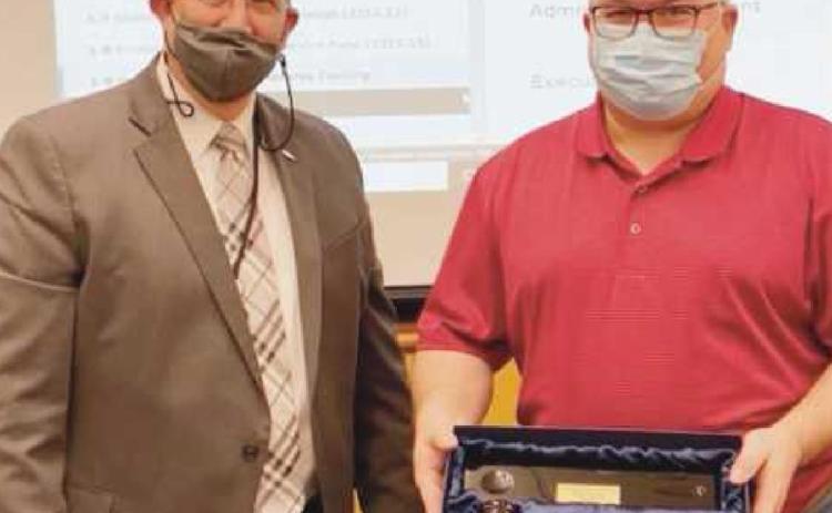 Superintendent Ed Ewers, left, presents board president Ken Sutter of Rossford with a token of appreciation for his two-year service as president.