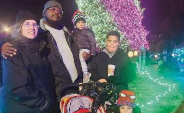 From left: Jessica Fausnaugh, Lendale Rogers Jr., Christian Rogers, Isaiah Walton and Lendale Rogers III press paws at the Toledo Zoo’s Lights Before Christmas.